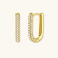 Close-up of gold-plated sterling silver huggie earrings with pave-set crystals creating a continuous sparkle around the hoop