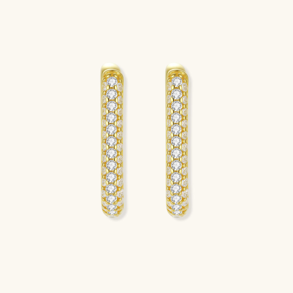 Close-up of gold-plated sterling silver huggie earrings with pave-set crystals creating a continuous sparkle around the hoop