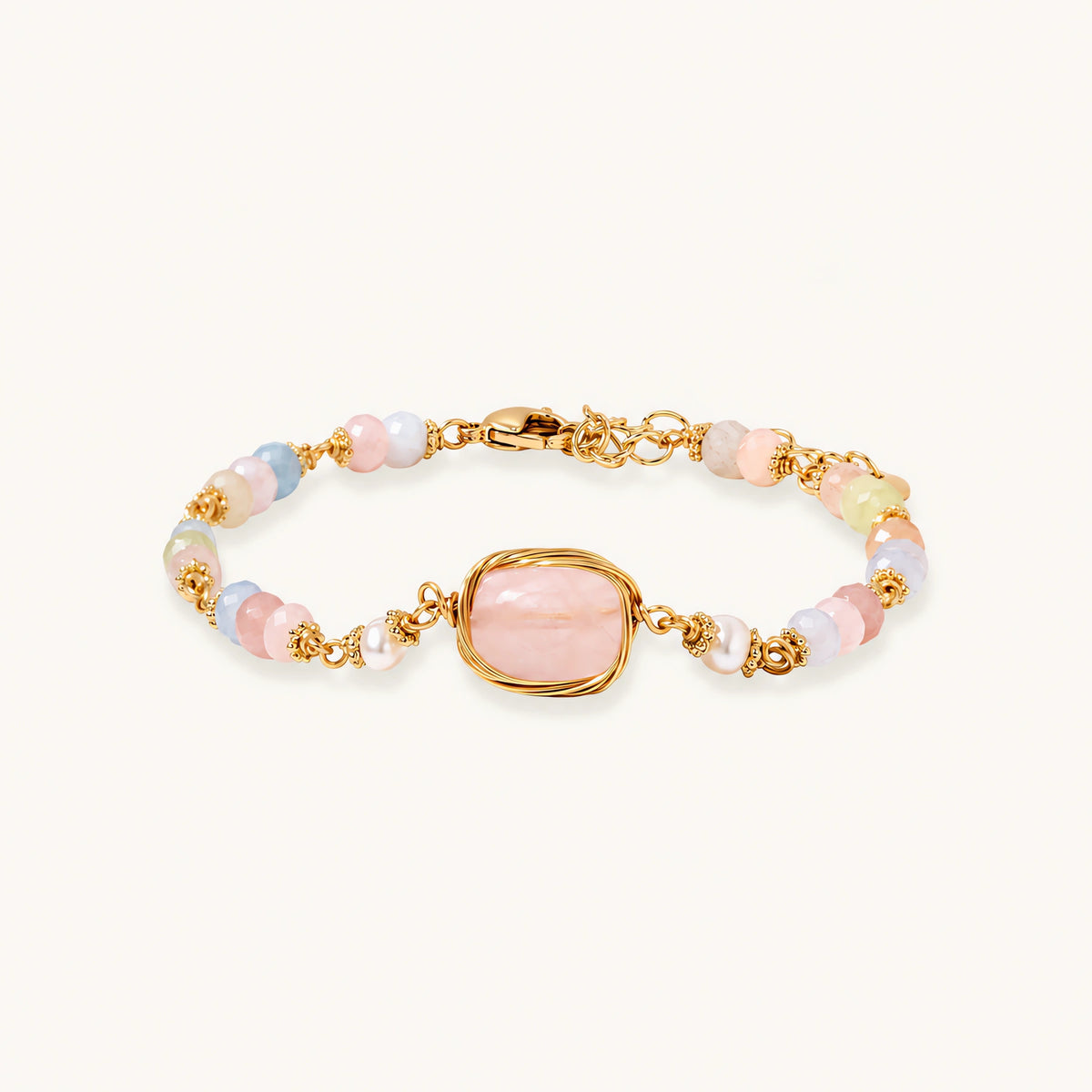Delicate beaded bracelet with pastel rose quartz, pearls, and pink cushion-cut centerpiece in gold-plated setting