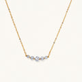 Delicate 14K gold-plated necklace with five graduated zirconia stones arranged in a curved arc on fine chain