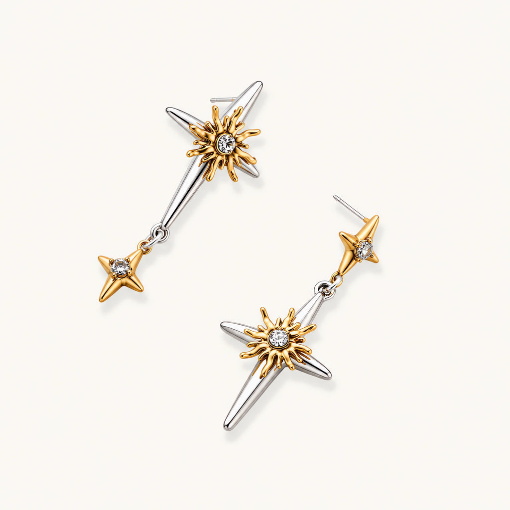Layered silver-toned necklace set with cross pendant and gold sun charm detail, matching drop earrings on white background.