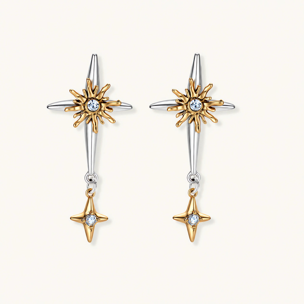 Layered silver-toned necklace set with cross pendant and gold sun charm detail, matching drop earrings on white background.