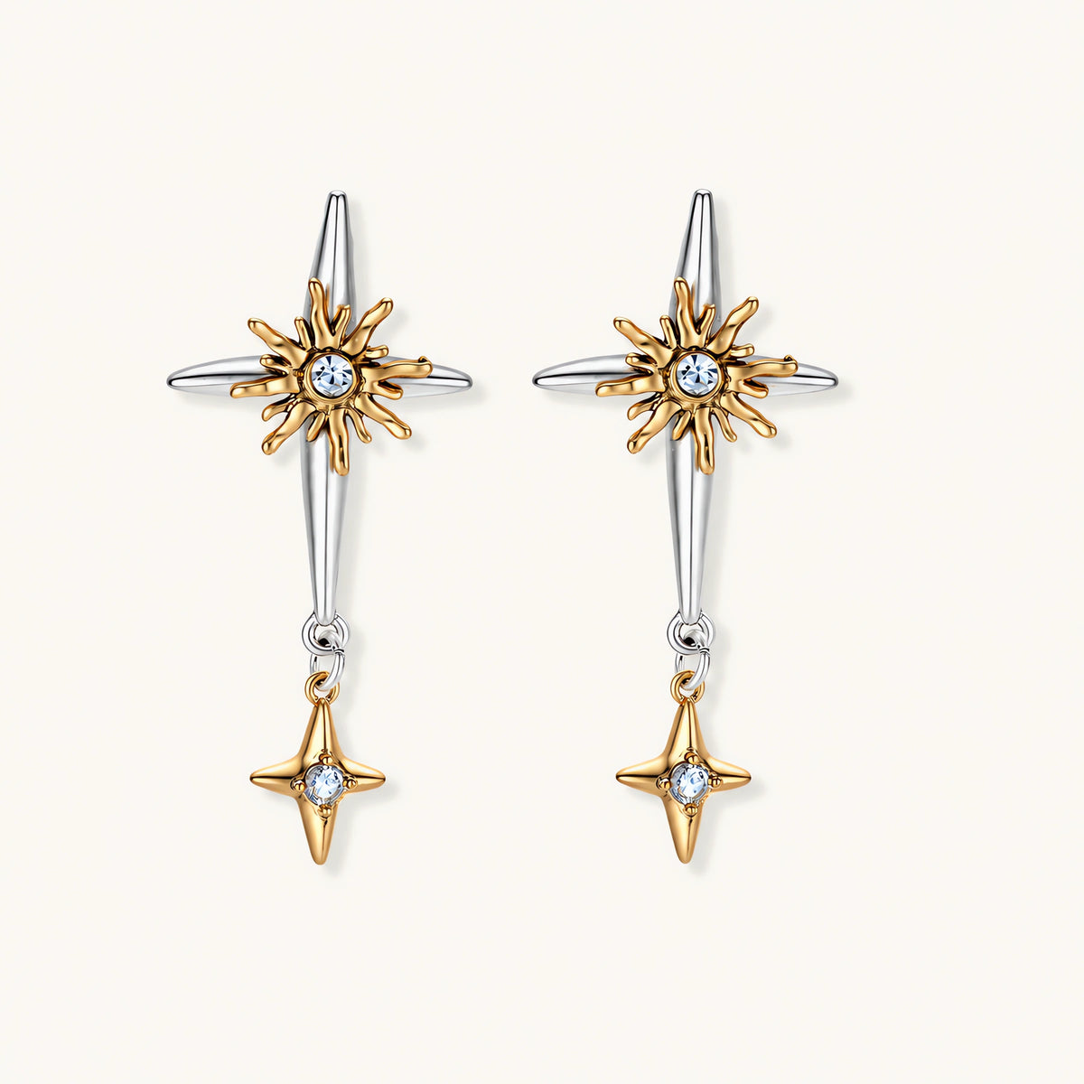 Layered silver-toned necklace set with cross pendant and gold sun charm detail, matching drop earrings on white background.