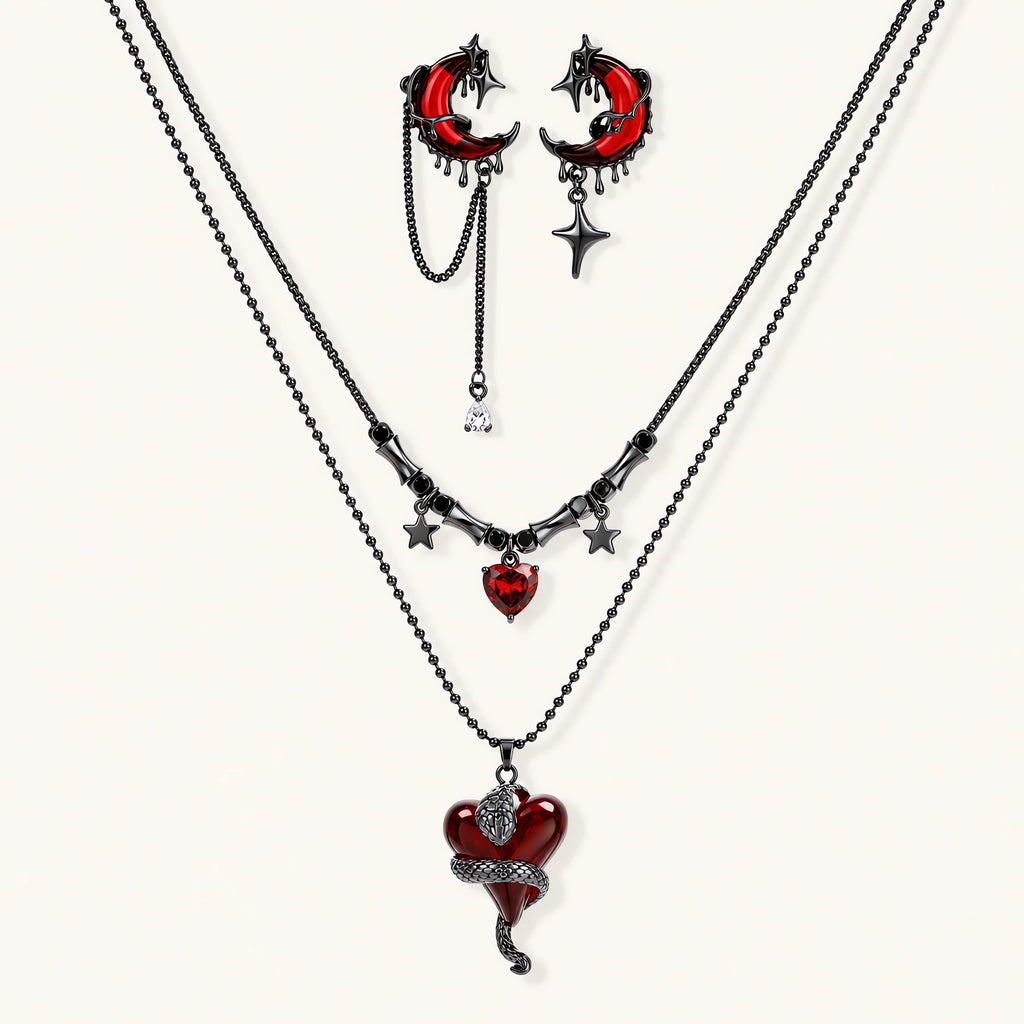 Gothic jewelry set with asymmetrical black metal earrings featuring red crescent moons, stars, and layered necklaces with heart pendants