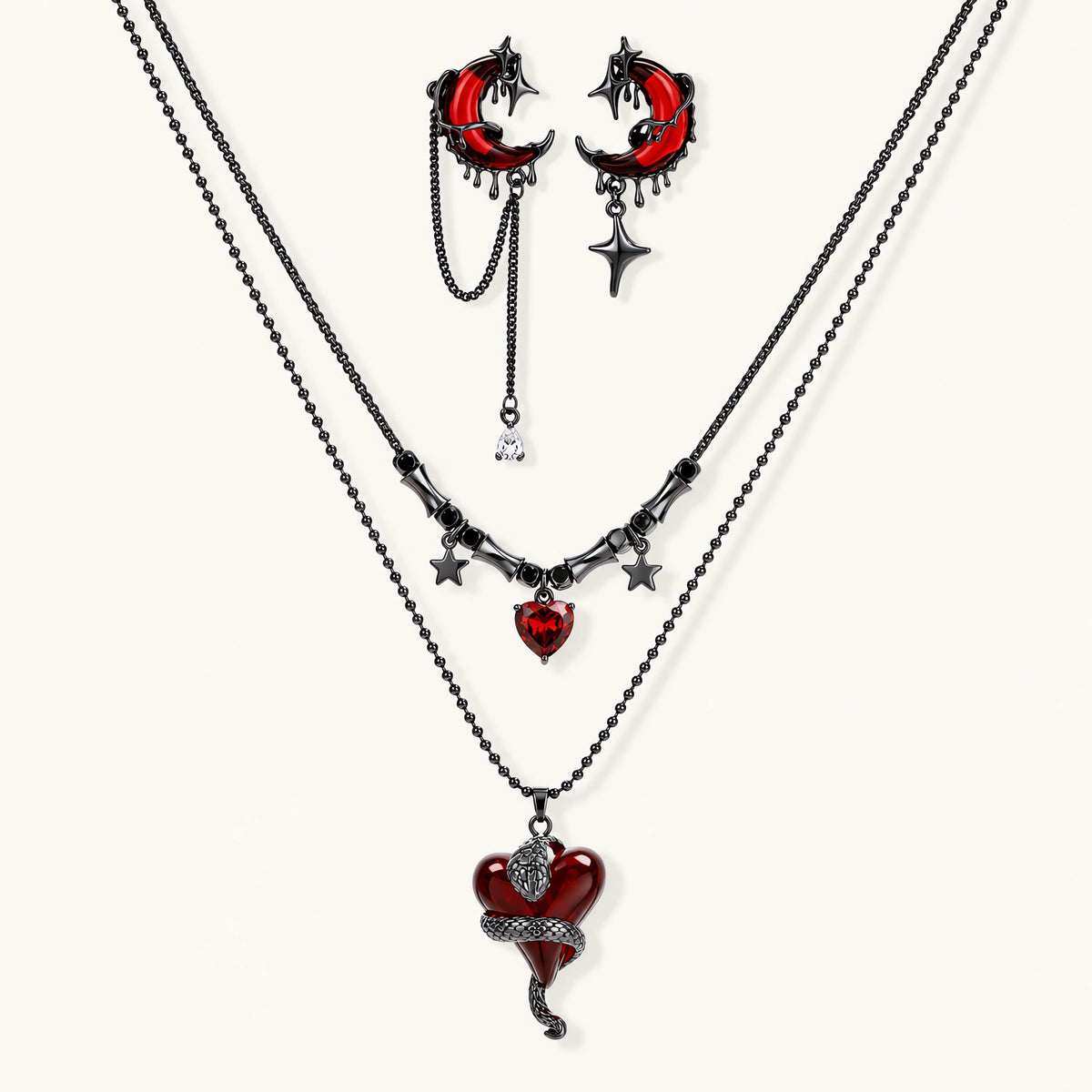 Gothic jewelry set with asymmetrical black metal earrings featuring red crescent moons, stars, and layered necklaces with heart pendants