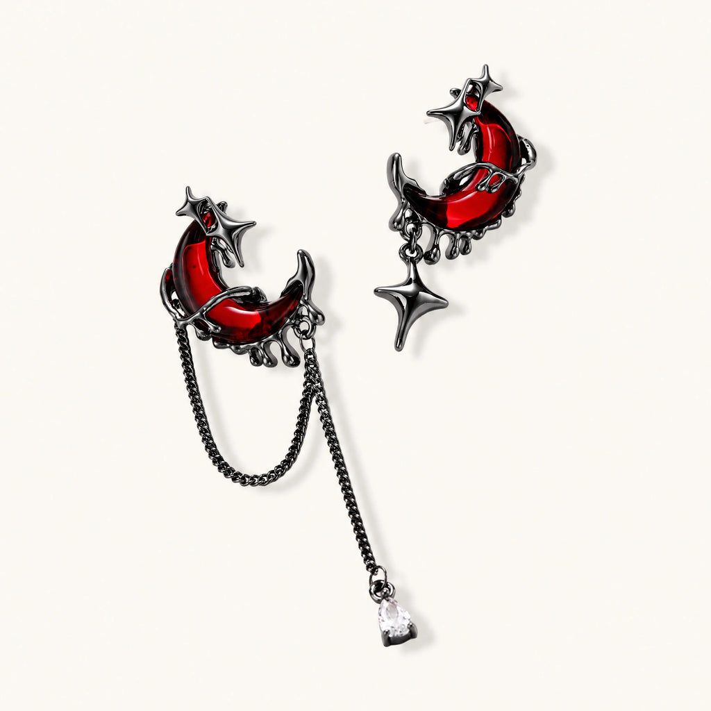 Gothic jewelry set with asymmetrical black metal earrings featuring red crescent moons, stars, and layered necklaces with heart pendants