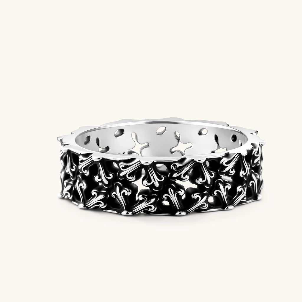 Sterling silver band ring with oxidized black fleur-de-lis cutwork pattern, 6.5mm wide, on white background.