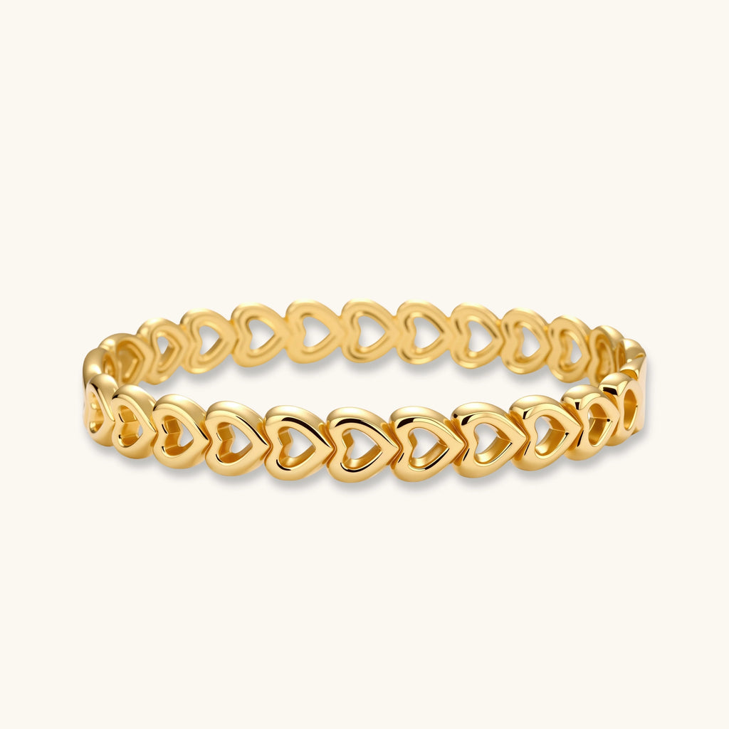 Gold 18K plated stainless steel bangle with continuous open heart links, high-polish finish, on white background.